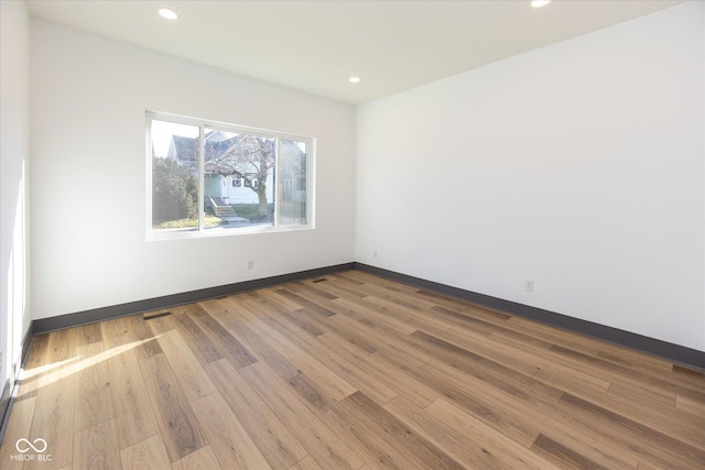 unfurnished room featuring hardwood / wood-style floors