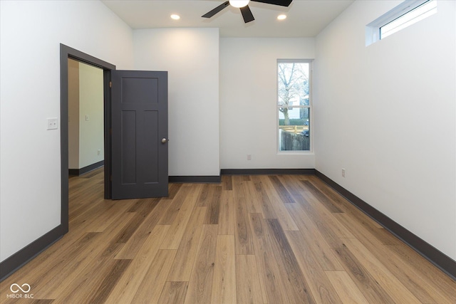 unfurnished room featuring ceiling fan and hardwood / wood-style flooring