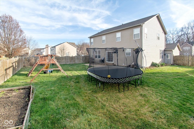 back of house with a playground, a trampoline, and a lawn