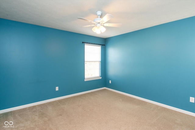 spare room with carpet flooring and ceiling fan