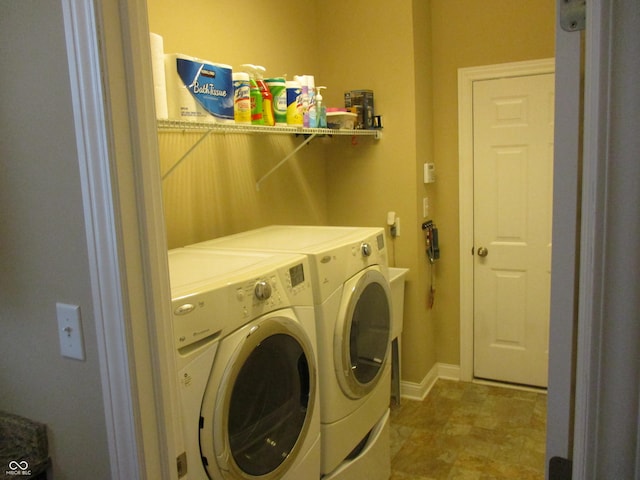 clothes washing area with washing machine and clothes dryer