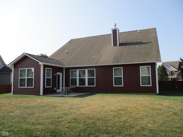 rear view of property with a yard and a patio