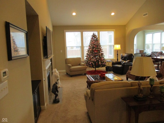 living room featuring light colored carpet and vaulted ceiling