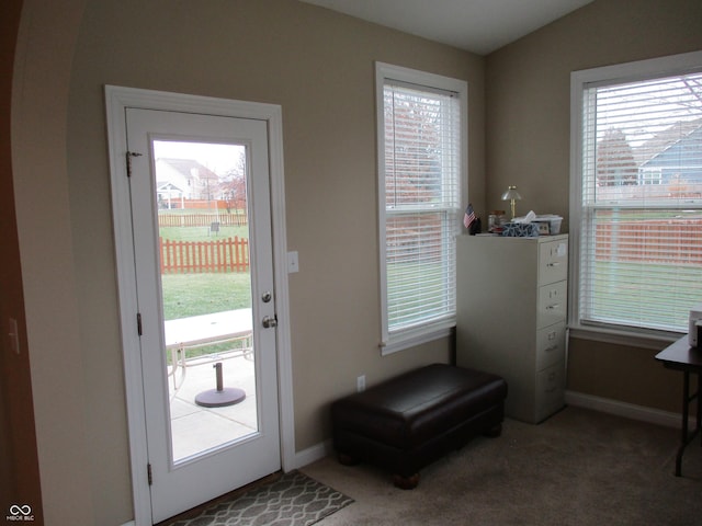 entryway with carpet flooring and lofted ceiling