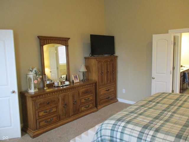 carpeted bedroom with connected bathroom