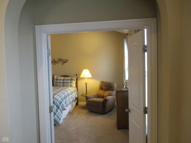 bedroom featuring light carpet