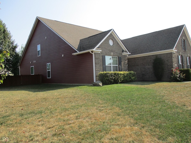 view of side of property with a yard