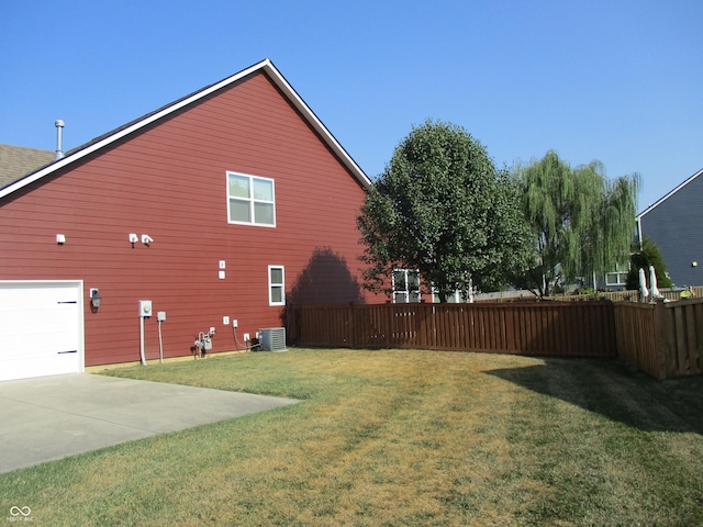 view of property exterior with a yard and central air condition unit