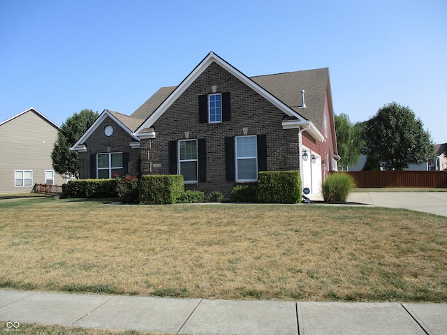 view of front property featuring a garage and a front lawn