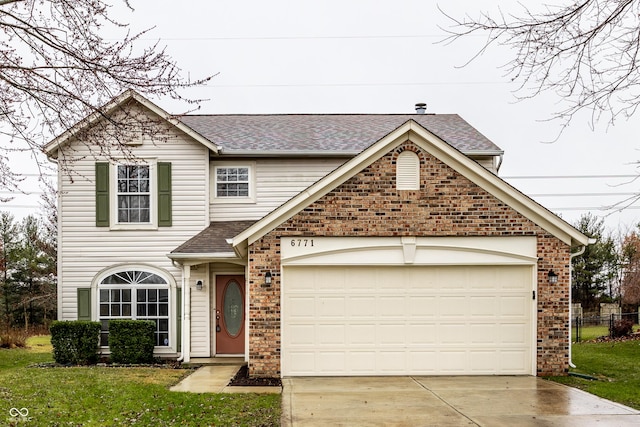 view of property featuring a front yard and a garage