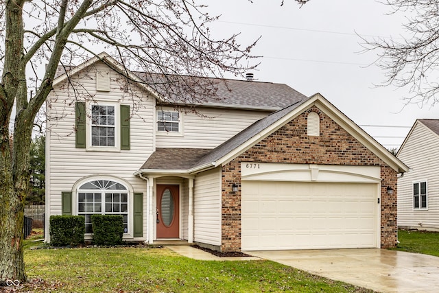 front of property with a front yard and a garage