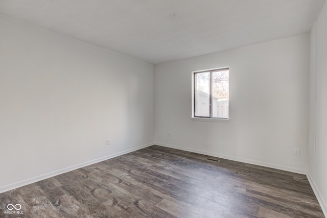 empty room featuring dark hardwood / wood-style flooring