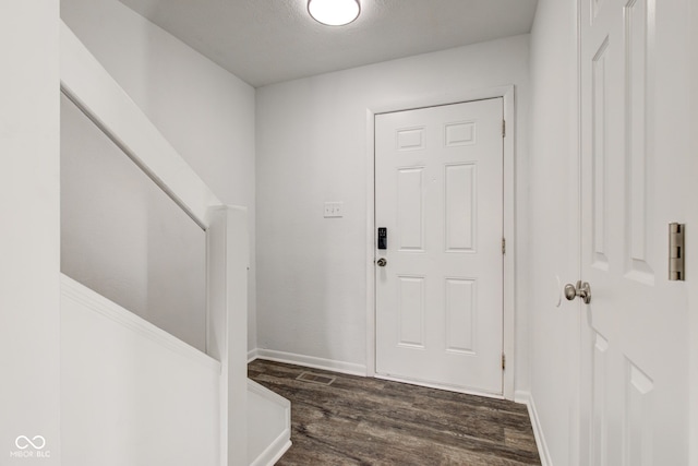 foyer entrance with dark hardwood / wood-style floors