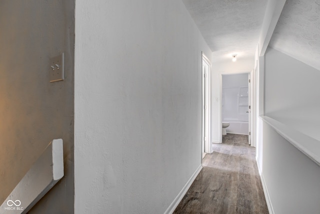 hall with hardwood / wood-style flooring and lofted ceiling