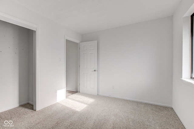 unfurnished bedroom featuring light colored carpet