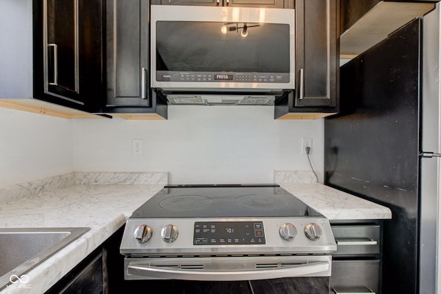 kitchen with dark brown cabinetry and stainless steel appliances