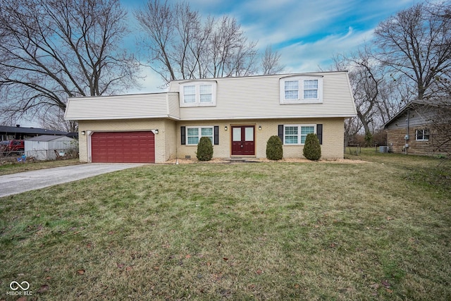 view of front of house featuring a garage and a front lawn