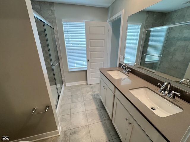 bathroom with tile patterned flooring, vanity, and walk in shower