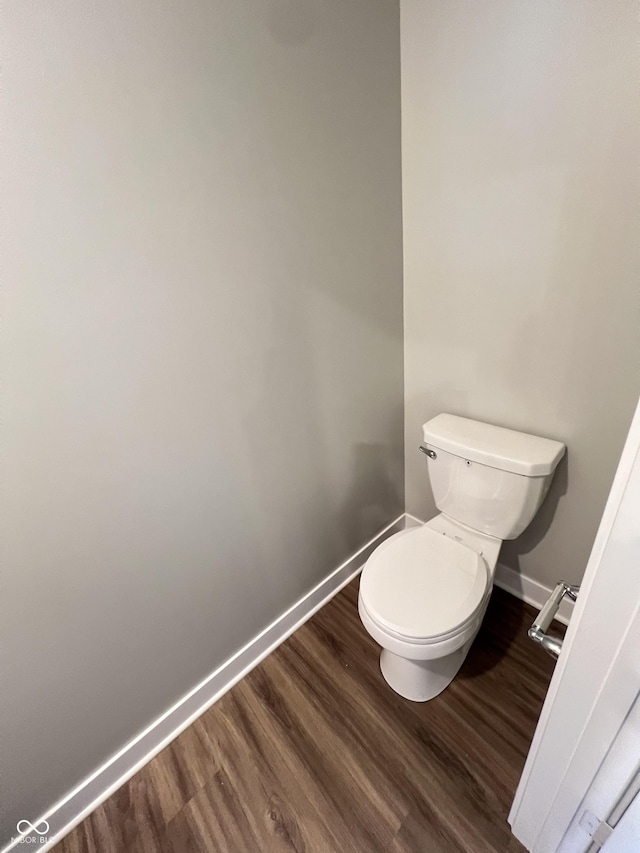 bathroom featuring hardwood / wood-style floors and toilet