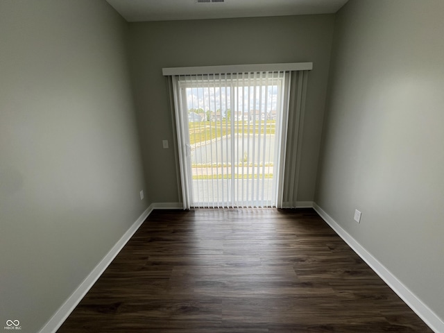 spare room featuring dark hardwood / wood-style flooring