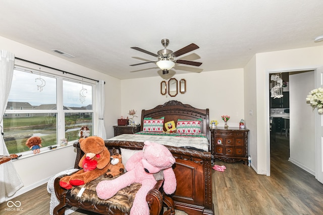 bedroom with dark hardwood / wood-style floors and ceiling fan