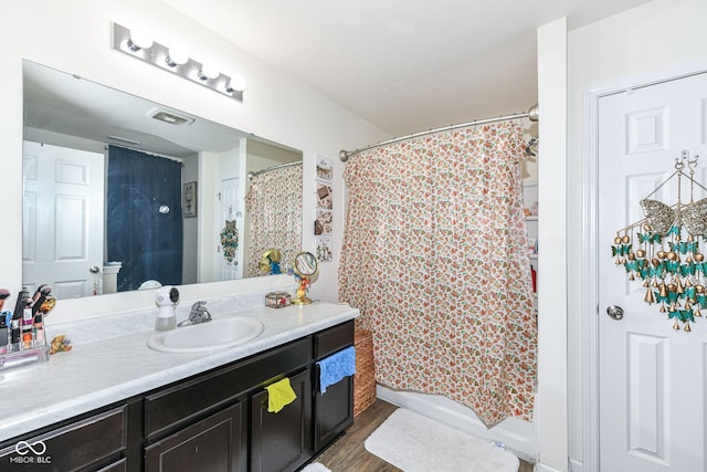 bathroom featuring vanity and wood-type flooring