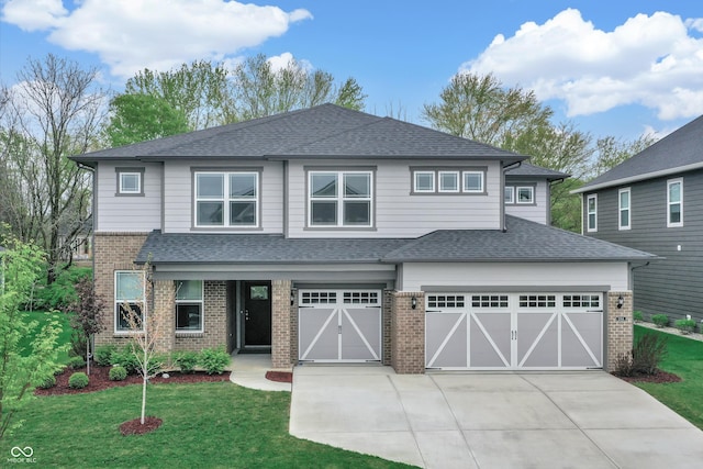 view of front of property with a garage and a front lawn