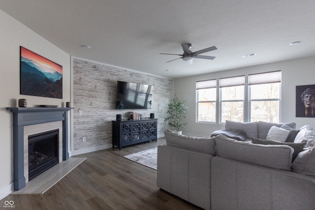 living room with dark hardwood / wood-style flooring and ceiling fan