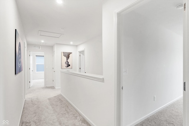 corridor featuring light colored carpet