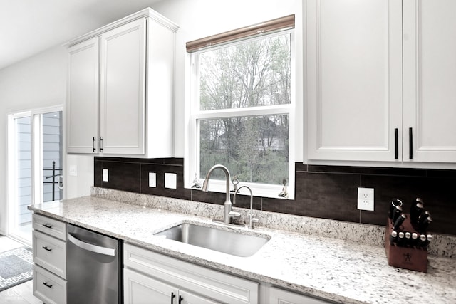 kitchen with dishwasher, sink, and a healthy amount of sunlight