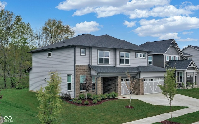 view of front of property with a front yard and a garage