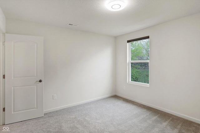 empty room with light colored carpet