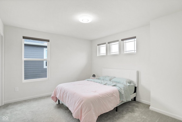 bedroom featuring light colored carpet