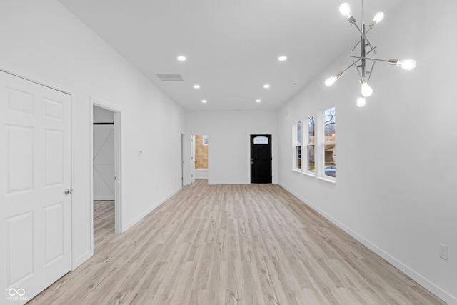 interior space with a chandelier and light hardwood / wood-style floors