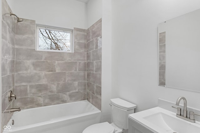 full bathroom with toilet, vanity, and tiled shower / bath