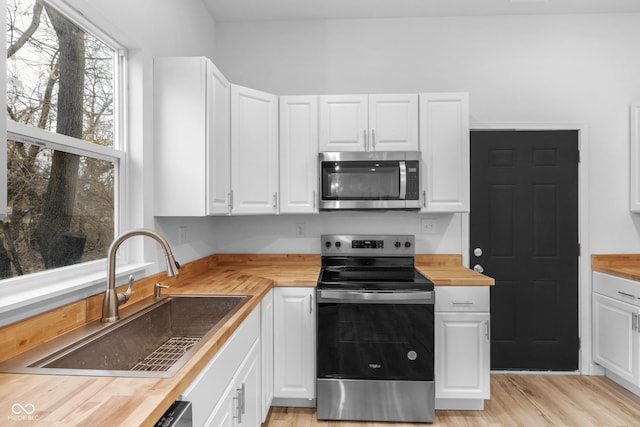 kitchen with white cabinets, sink, and stainless steel appliances