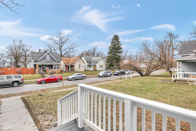 wooden terrace featuring covered porch and a yard