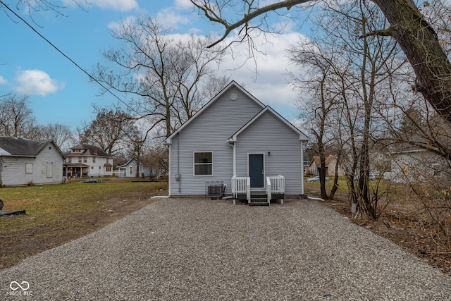 rear view of property featuring a yard