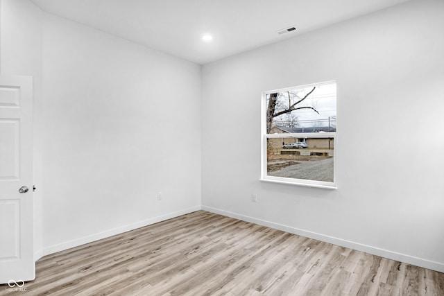 unfurnished room with light hardwood / wood-style floors