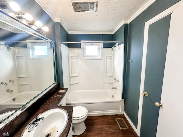 full bathroom with ornamental molding, tub / shower combination, a healthy amount of sunlight, and wood-type flooring