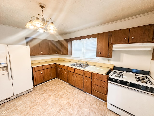 kitchen featuring sink, a chandelier, a textured ceiling, pendant lighting, and white appliances