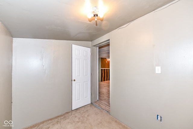 carpeted spare room with lofted ceiling