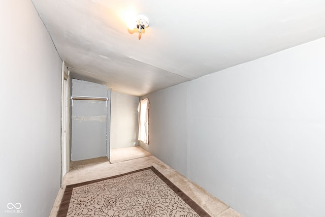 interior space featuring light carpet and lofted ceiling