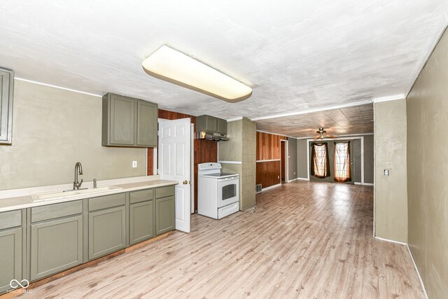4925 W Raymond St, Indianapolis, IN 46241 - kitchen featuring white electric range oven, light wood finished floors, a ceiling fan, light countertops, and under cabinet range hood
