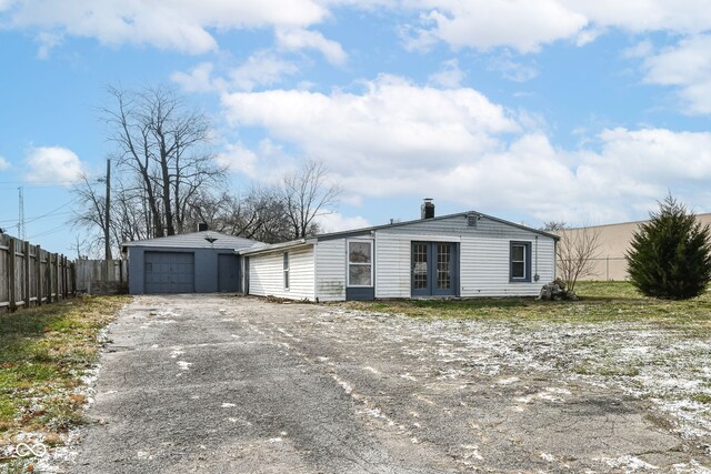 4925 W Raymond St, Indianapolis, IN 46241 - view of front of property featuring french doors, a detached garage, and a chimney