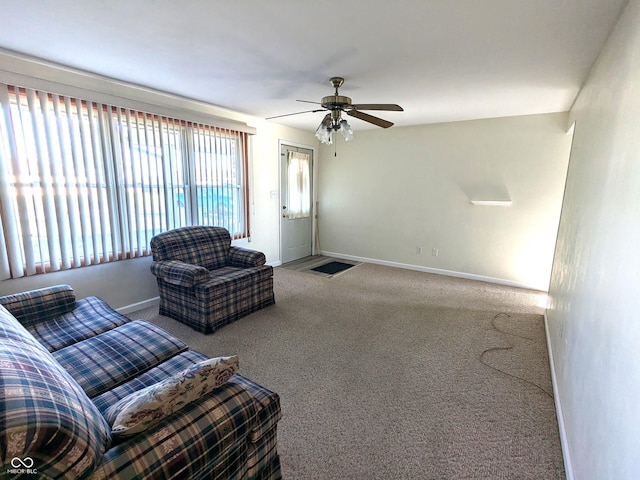 carpeted living room with ceiling fan