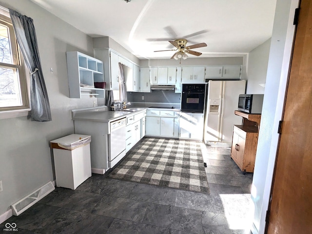 kitchen with ceiling fan, white cabinetry, white appliances, and sink