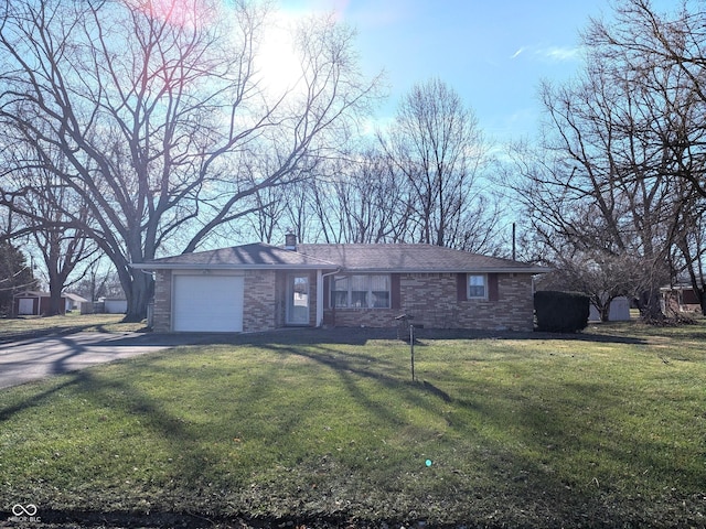 ranch-style house featuring a garage and a front lawn