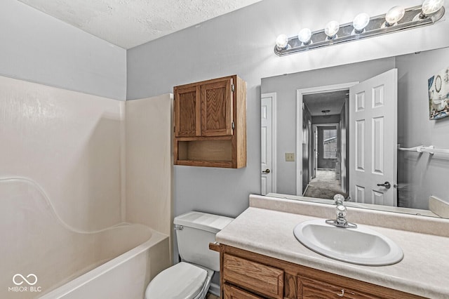 full bathroom with vanity, shower / bathtub combination, toilet, and a textured ceiling