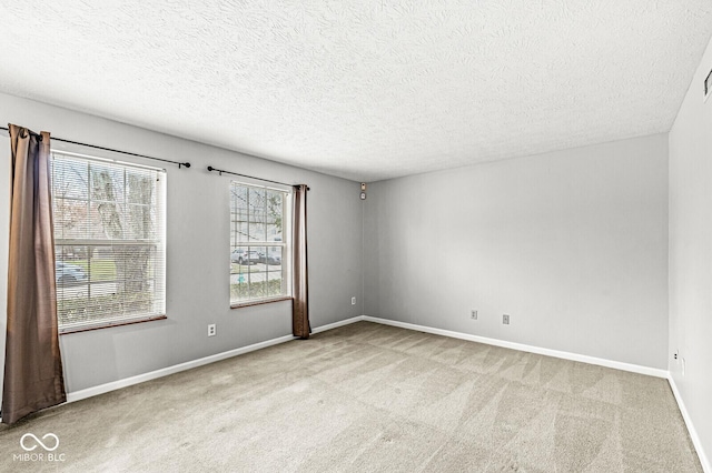 carpeted spare room with a textured ceiling